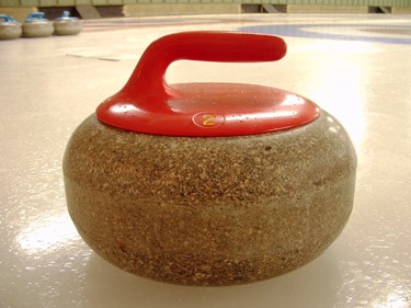 Pictured is a Curling "Rock", a a stone used in the winter sport of Curling.  Photograph by Brad Harrison of Saskatchewan, Canada.